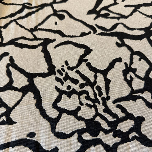 Close-up of a black floral pattern on beige fabric