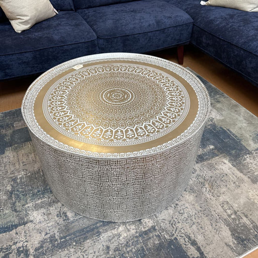 Decorative round table with intricate design in a living room setting