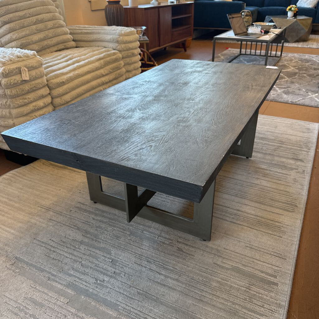 Large gray coffee table in a living room setting with furniture and decor.
