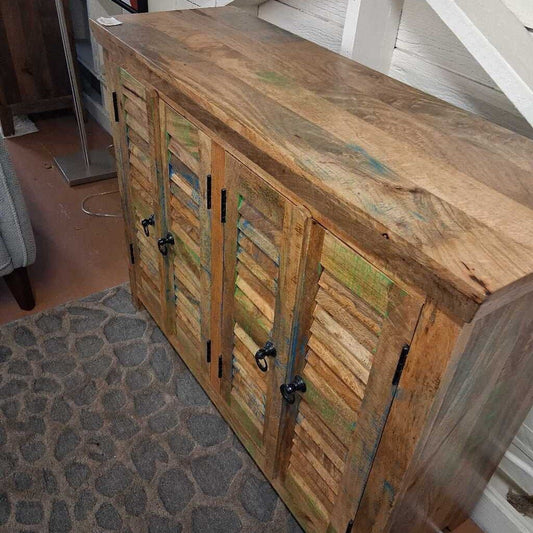 Wooden cabinet with shutter doors in a room setting