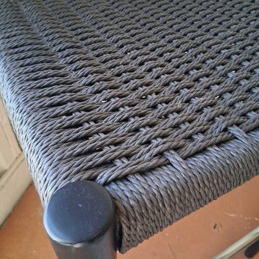Close-up of a woven chair seat with a textured surface