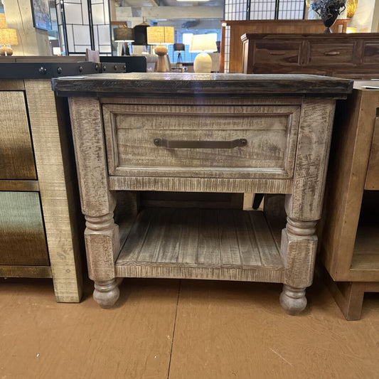 Wooden side table with a drawer in a furniture store setting