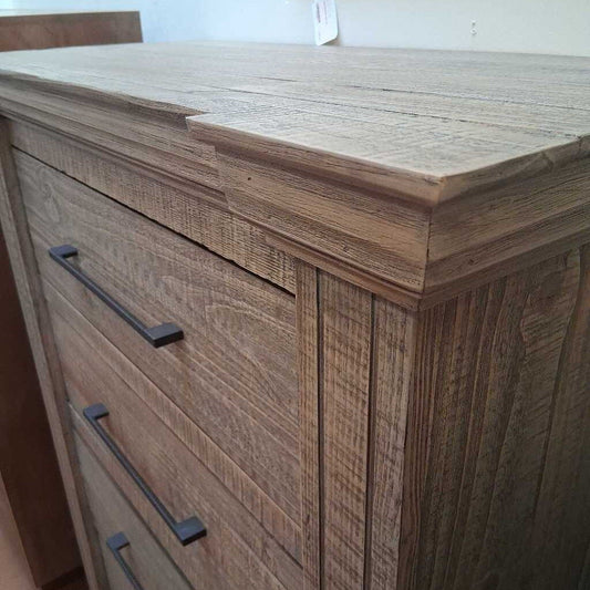 Wooden cabinet with black handles in a room setting