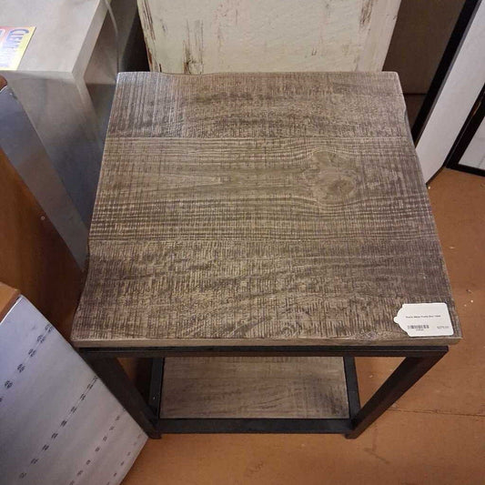 Wooden side table with a worn finish in an indoor setting