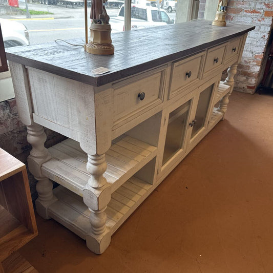 Wooden kitchen island with a dark countertop in a store setting