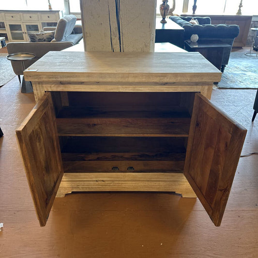 Wooden cabinet with open doors on a wooden floor in a living room setting.