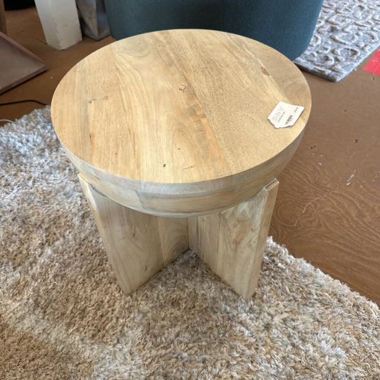 Wooden stool on a carpeted floor with a tag attached