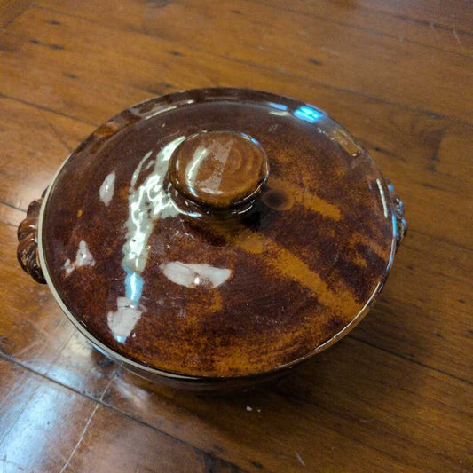 Ceramic dish with lid on a wooden surface