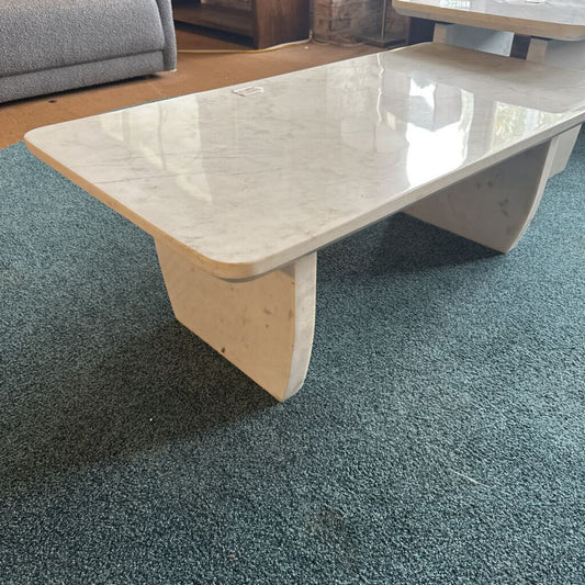 Coffee table with marble-like surface on a blue carpet