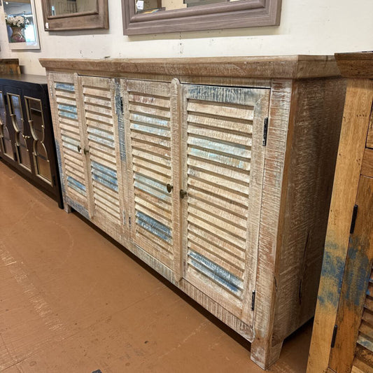 Wooden cabinet with slatted doors on a brown floor