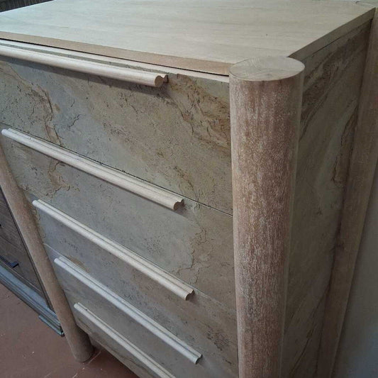 Wooden cabinet with marble-like texture on a tiled floor