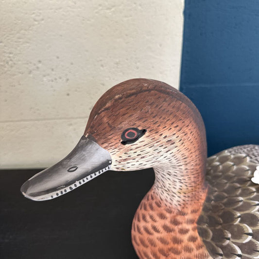 Close-up of a duck decoy with a detailed head and neck.