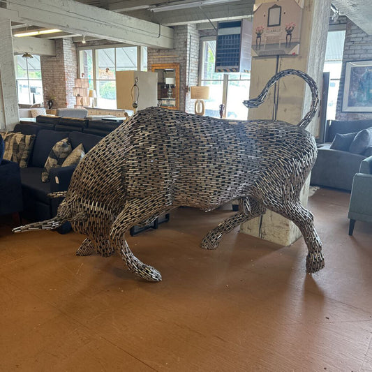 Bull sculpture made of metal sticks in a living room setting