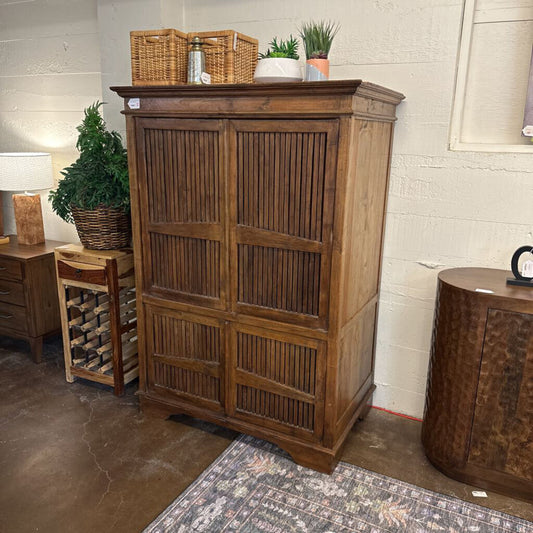 Wooden cabinet with decorative items in a room setting