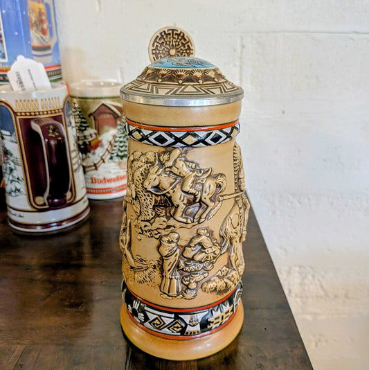 Decorative ceramic Stein with intricate designs on a wooden surface.