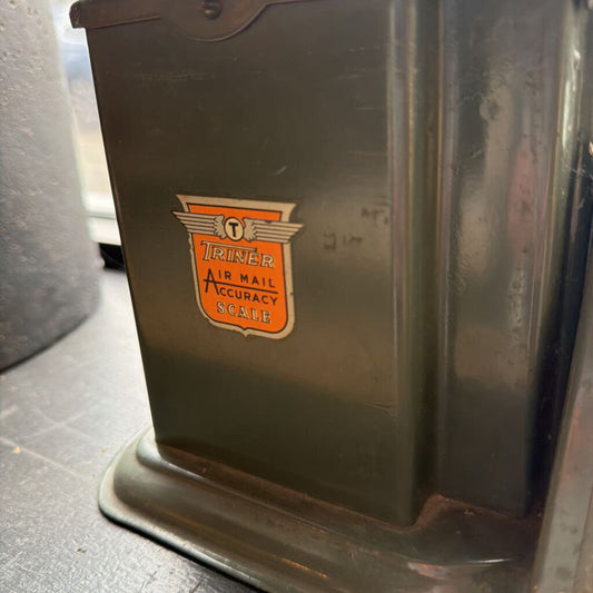 Vintage Triner air mail accuracy scale on a gray surface