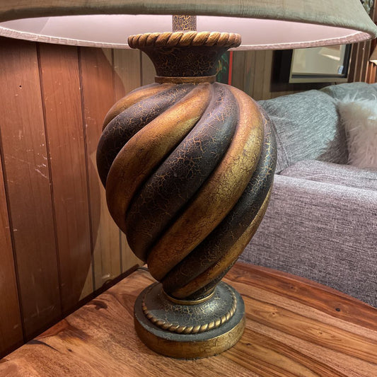 Decorative lamp with a textured base on a wooden surface