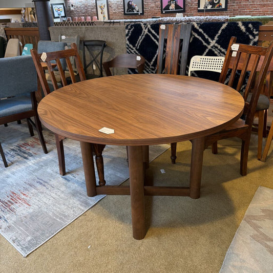Wooden dining table with chairs in a showroom setting