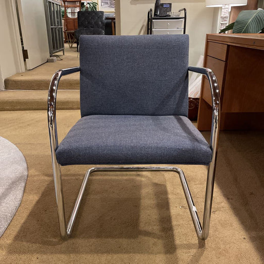 Blue chair with chrome frame in a room setting