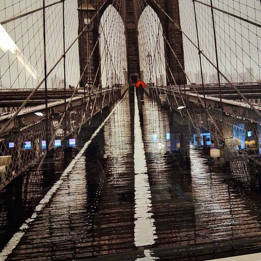 Reflections on the surface of the Brooklyn Bridge at night.