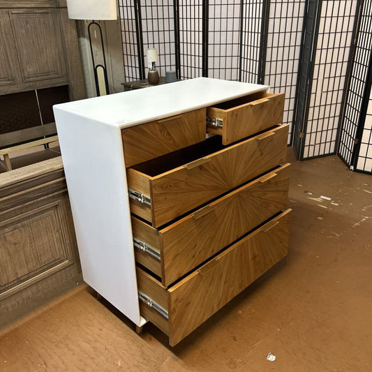 Wooden dresser with white top in a room setting