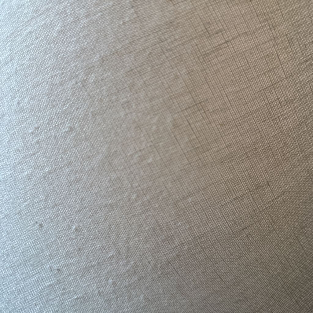Close-up of beige fabric with a subtle pattern