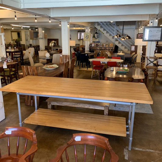 Wooden table with metal legs in a furniture store setting