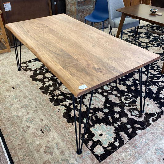 Wooden table with metal legs on a patterned rug