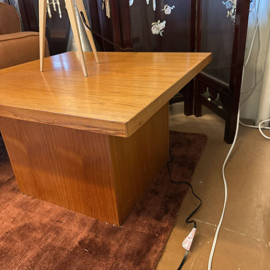 Wooden desk with a mirror on top in a room setting