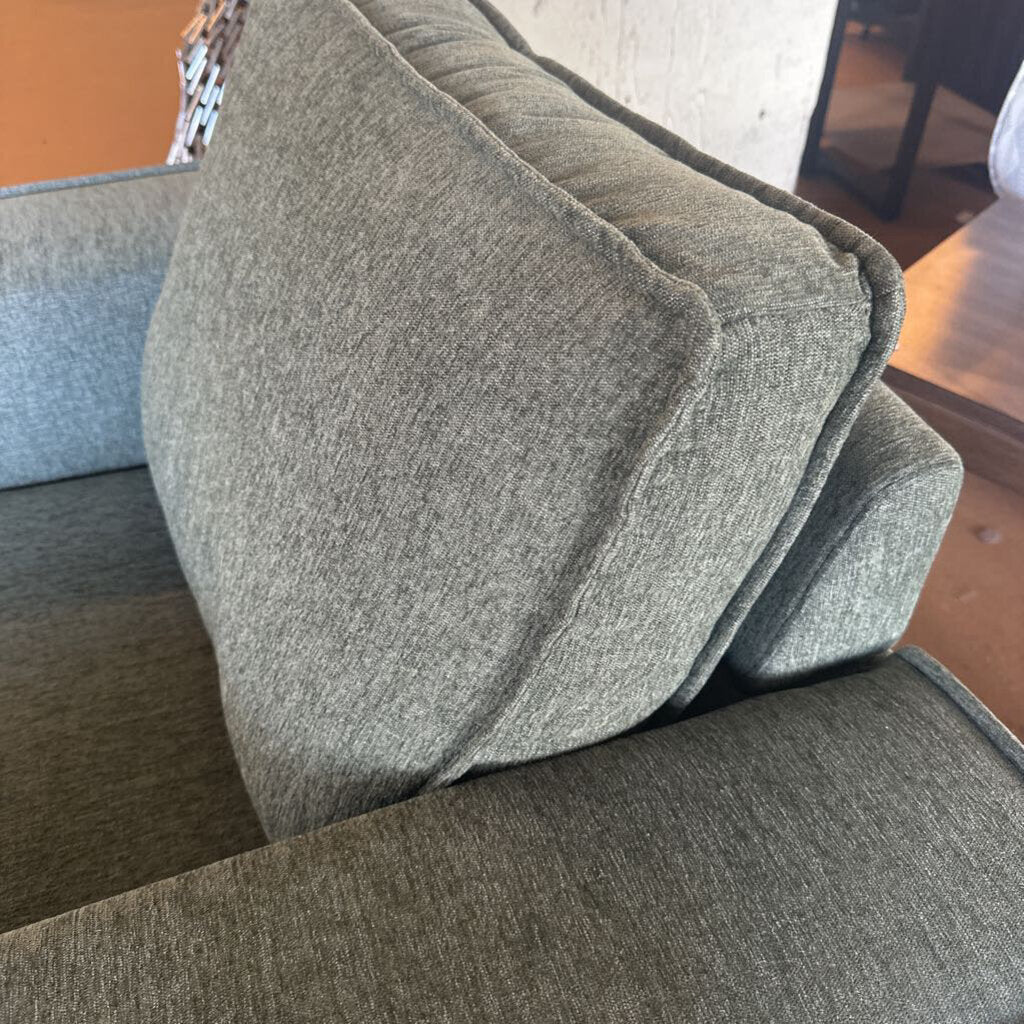 Gray cushion on a sofa with a blurred background