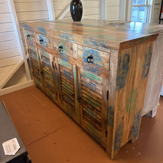 Wooden sideboard with distressed finish in a room setting
