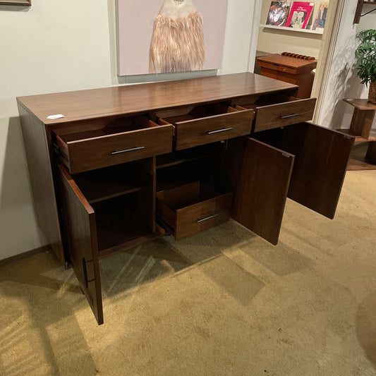 Wooden sideboard with open doors in a room setting
