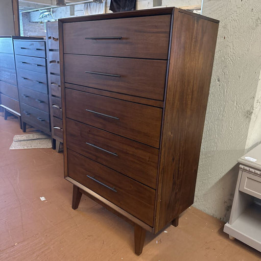 Wooden dresser with multiple drawers in a store setting