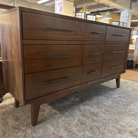 Wooden dresser with multiple drawers in a room setting