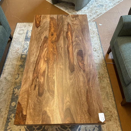 Wooden coffee table with a natural finish in a room setting