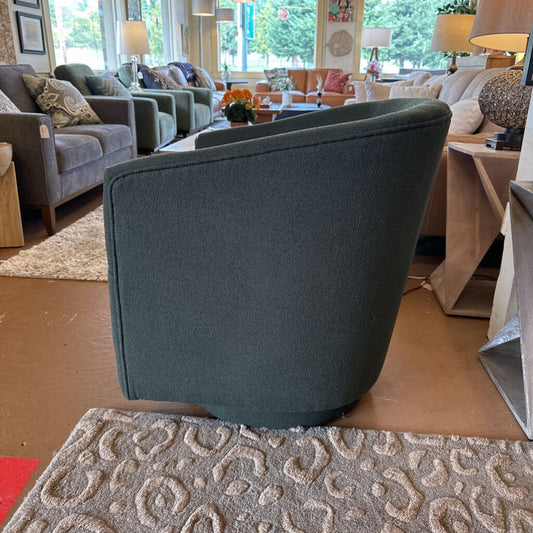 Gray armchair in a living room setting with furniture and decor.