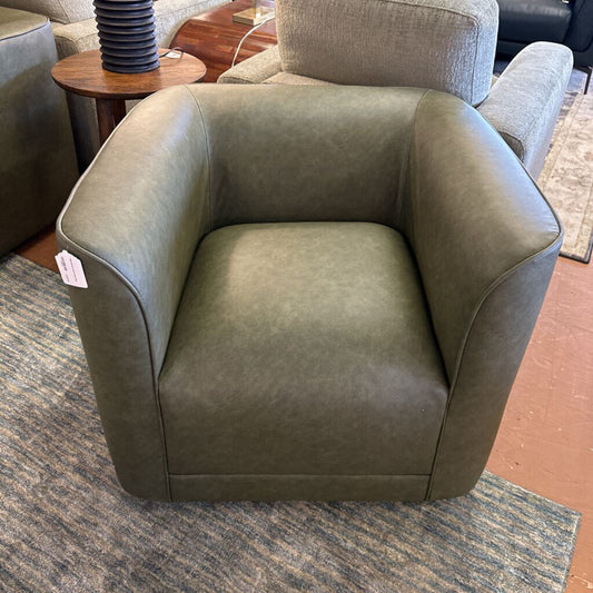 Brown armchair on a carpeted floor with a price tag attached
