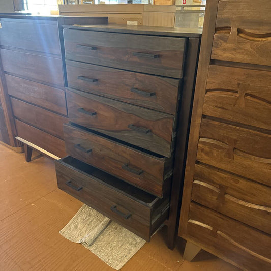 Wooden dresser with multiple drawers in a store setting