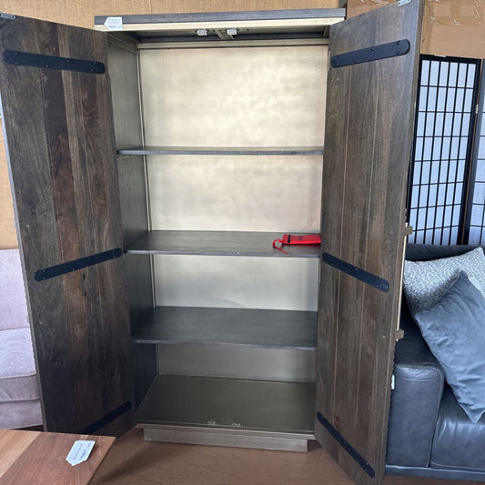 Wooden wardrobe with metal interior in a room with furniture and decor.