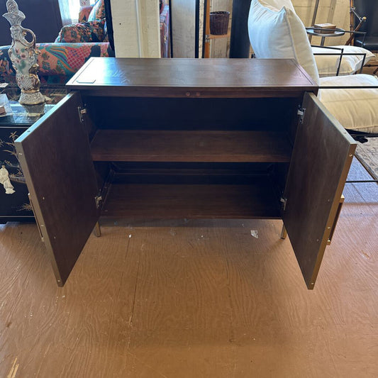 Wooden sideboard with open doors on a wooden floor