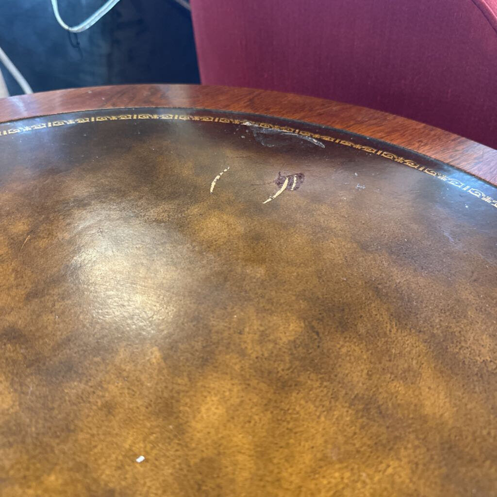 Round wooden table with a worn surface