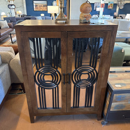 Wooden cabinet with decorative glass doors in a living room setting