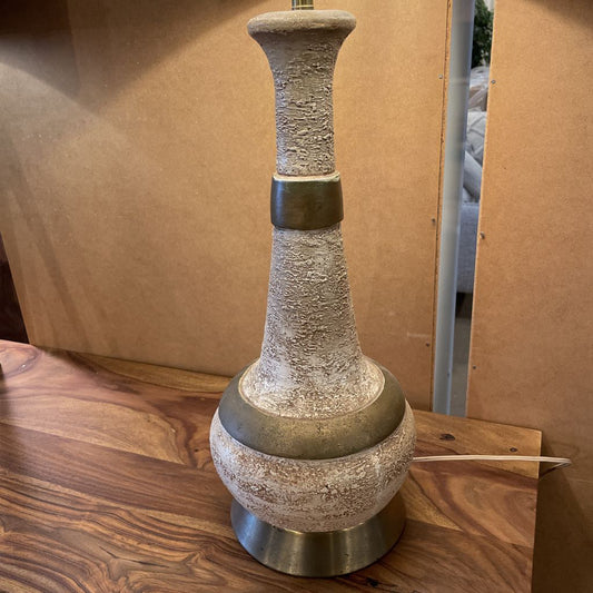 Decorative vase on a wooden surface with a cardboard box in the background