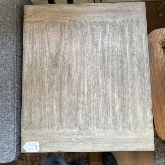 Wooden panel with a visible brand label on a carpeted floor