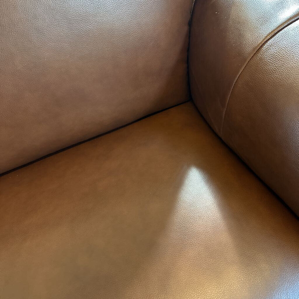 Close-up of a brown leather sofa corner