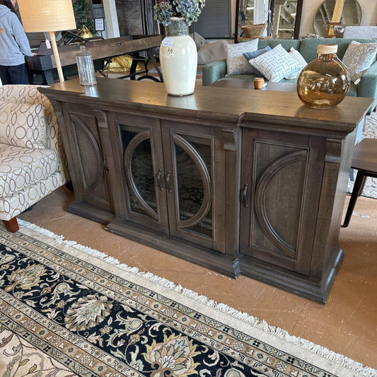 Wooden console table with decorative items in a living room setting