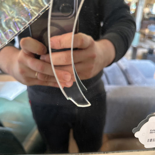 Person holding a phone with clear earbuds, blurred background