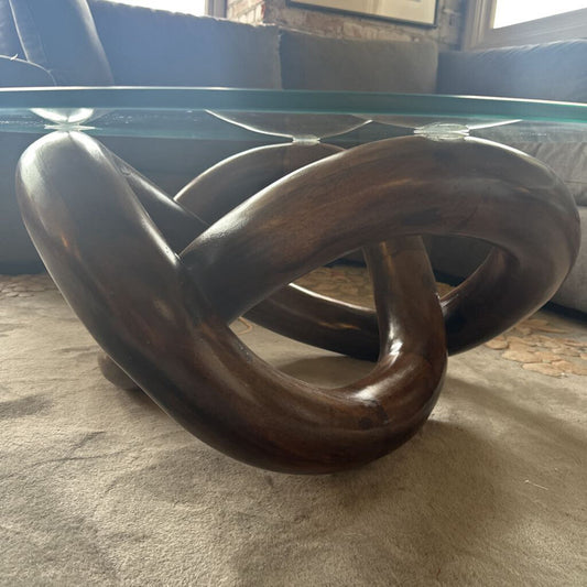 Decorative sculpture with interlocking rings on a textured surface