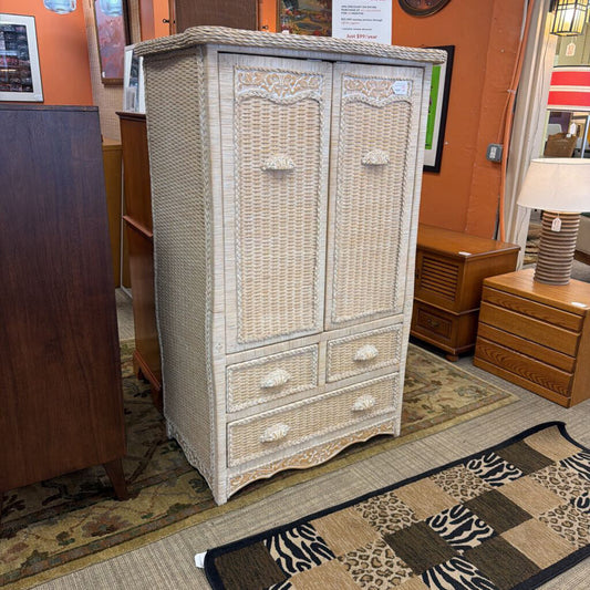 Wicker armoire in a room with other furniture and decor