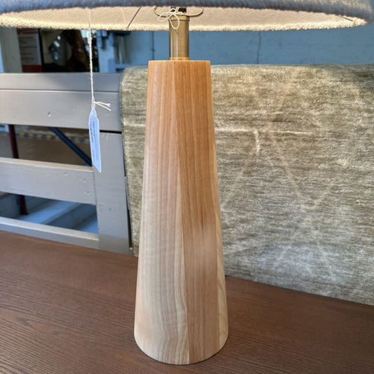 Wooden lamp with a tag on a wooden surface